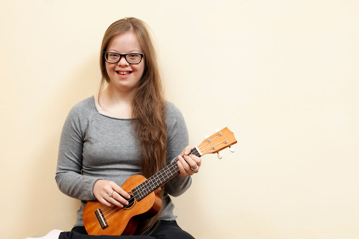 Young woman smiling and playing music